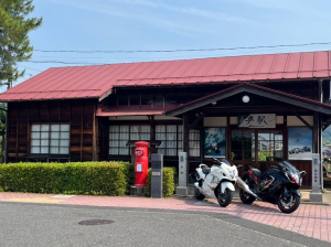 期間限定デザインの駅名板と駅舎と隼バイク