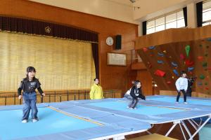 トランポリンでジャンプする子どもたち