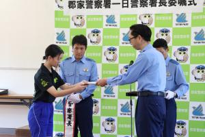 一日警察署長の委嘱状を受け取る八東小学校自転車クラブのメンバー