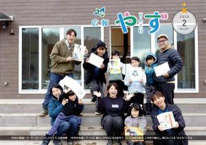 広報やず 令和8年2月号の表紙（アーティスト・イン・レジデンス参加アーティストと出前授業に参加した親子の集合写真）